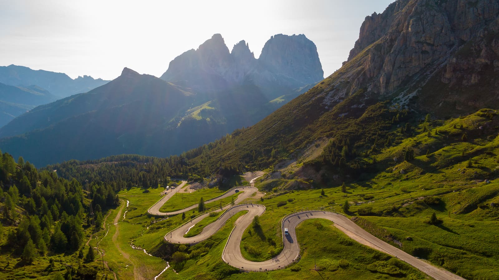 The Passo Pordoi winding through the Dolomites at golden hour.